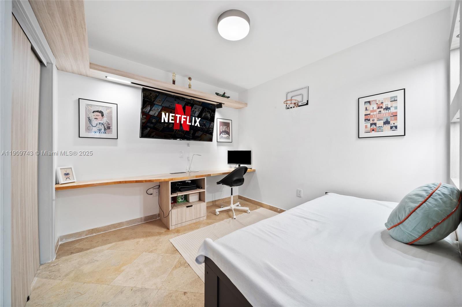 9401 Collins Avenue, Unit 205 Surfside, FL 33154 - Photo 23 of 36 a bedroom with a bed and a flat screen tv