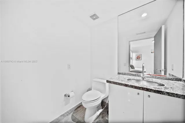 a living room with a bed and glass table