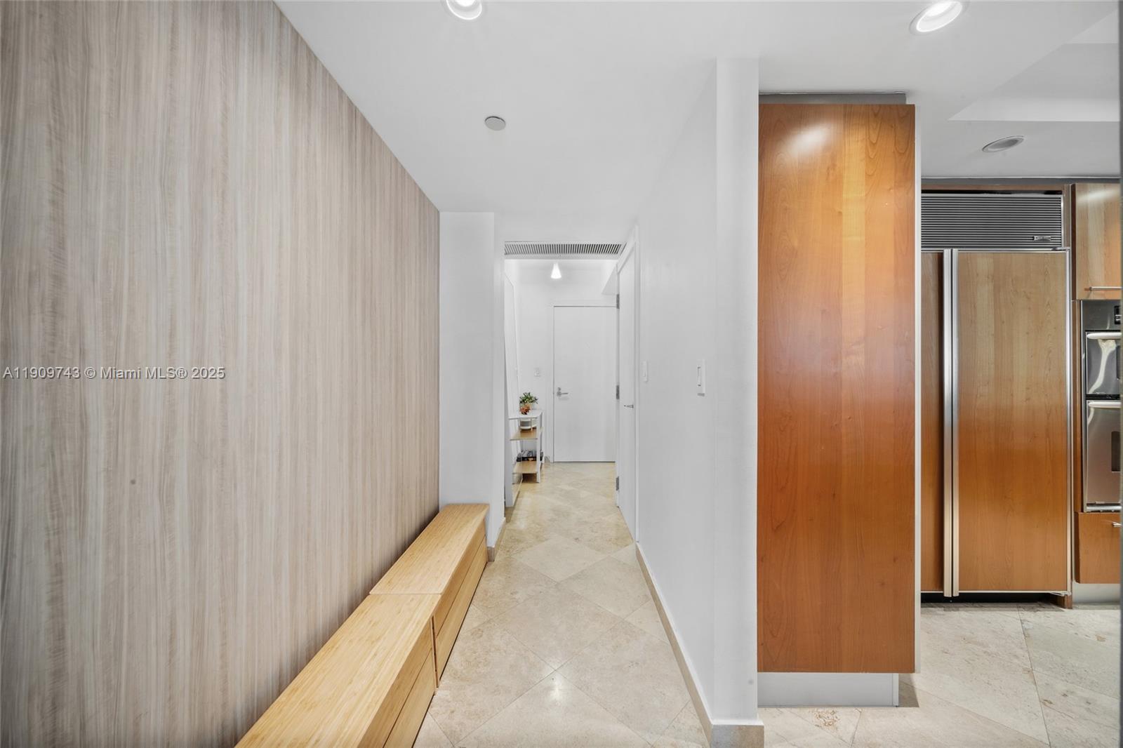 9401 Collins Avenue, Unit 205 Surfside, FL 33154 - Photo 9 of 36 a view of a hallway with wooden floor and a bathroom