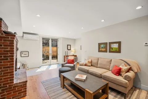 a living room with a couch and chairs