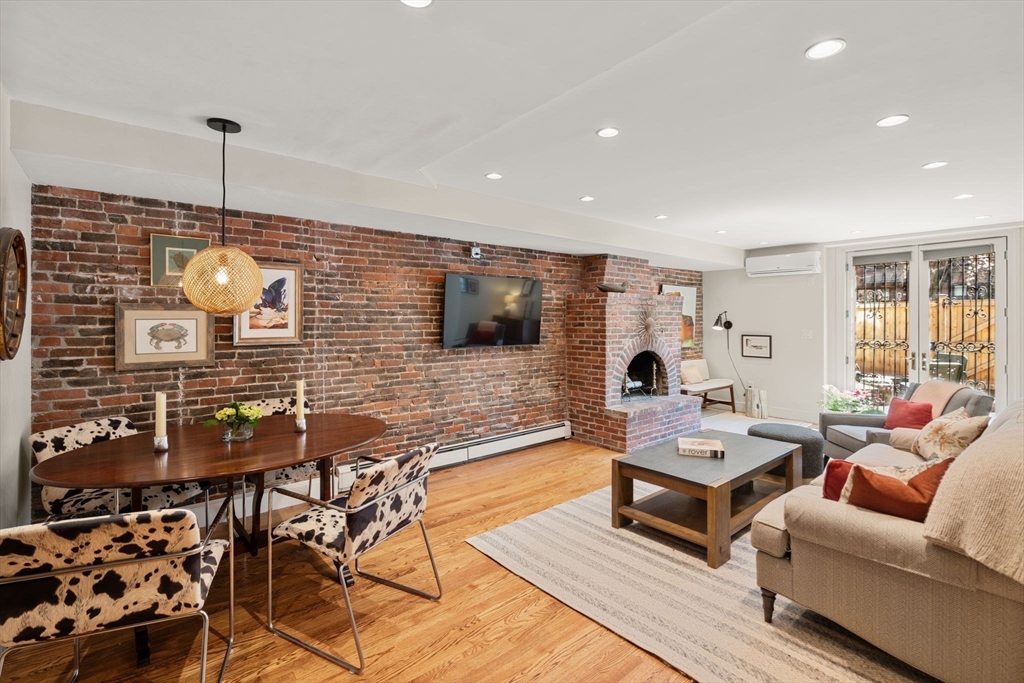 148 Warren Avenue, Unit 1 Boston, MA 02116 - Photo 2 of 28 a living room with furniture and a flat screen tv
