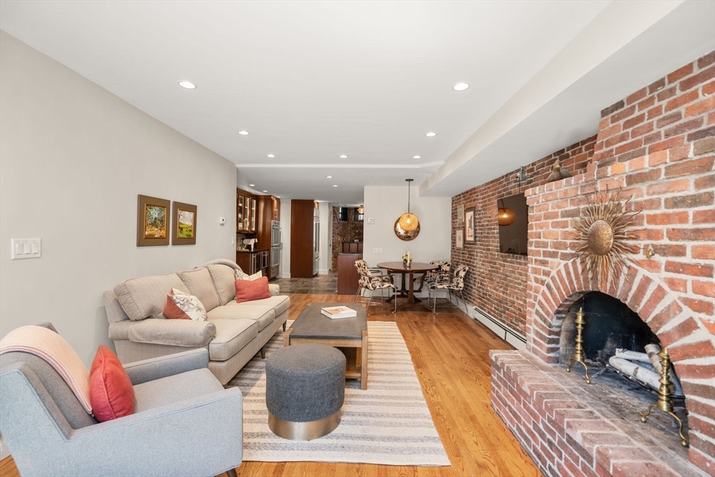 148 Warren Avenue, Unit 1 Boston, MA 02116 - Photo 4 of 28 a living room with furniture fireplace and a fireplace