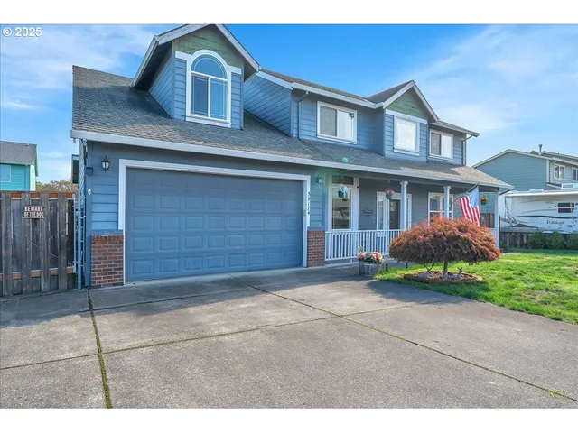 a front view of a house with a garden and entryway