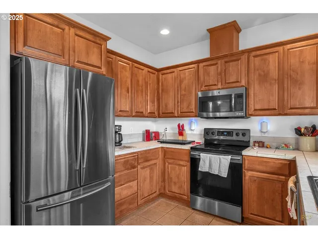 a kitchen with stainless steel appliances a stove sink microwave and cabinets