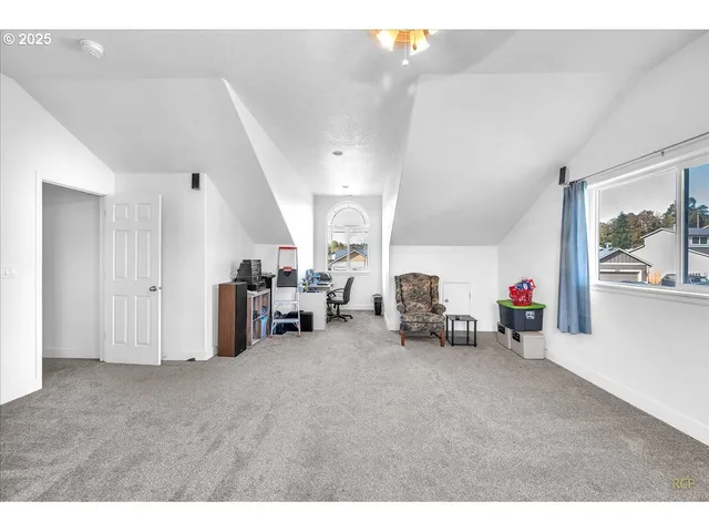 a living room with furniture a computer and a window