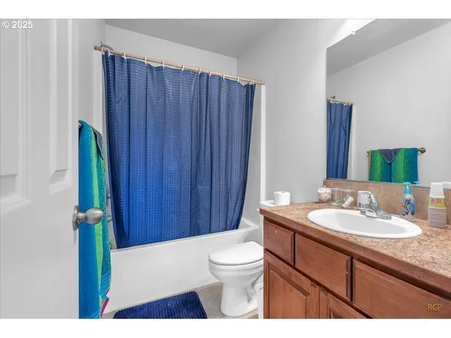 a bathroom with a sink mirror vanity and toilet