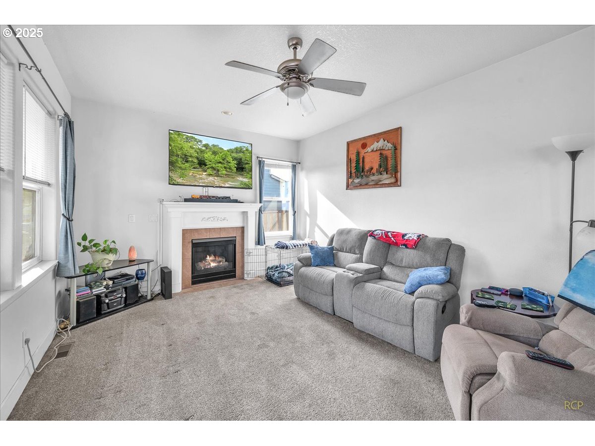 59174 Whitetail Avenue St. Helens, OR 97051 - Photo 5 of 34 a living room with furniture a fireplace and a flat screen tv