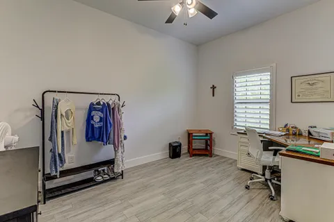 a bathroom with a granite countertop sink toilet a mirror and shower