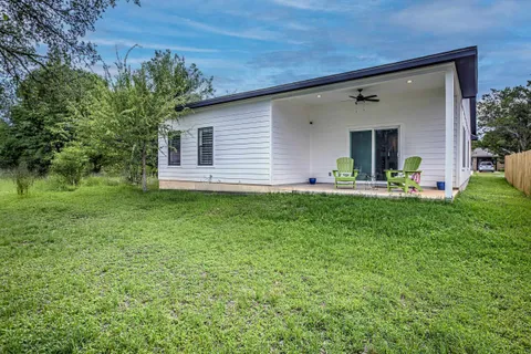 a front view of house with yard and outdoor seating