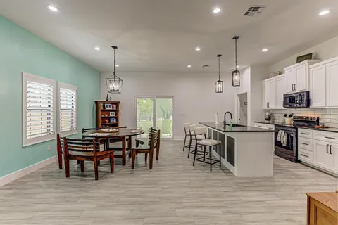 a view of a dining room with furniture wooden floor and chandelier