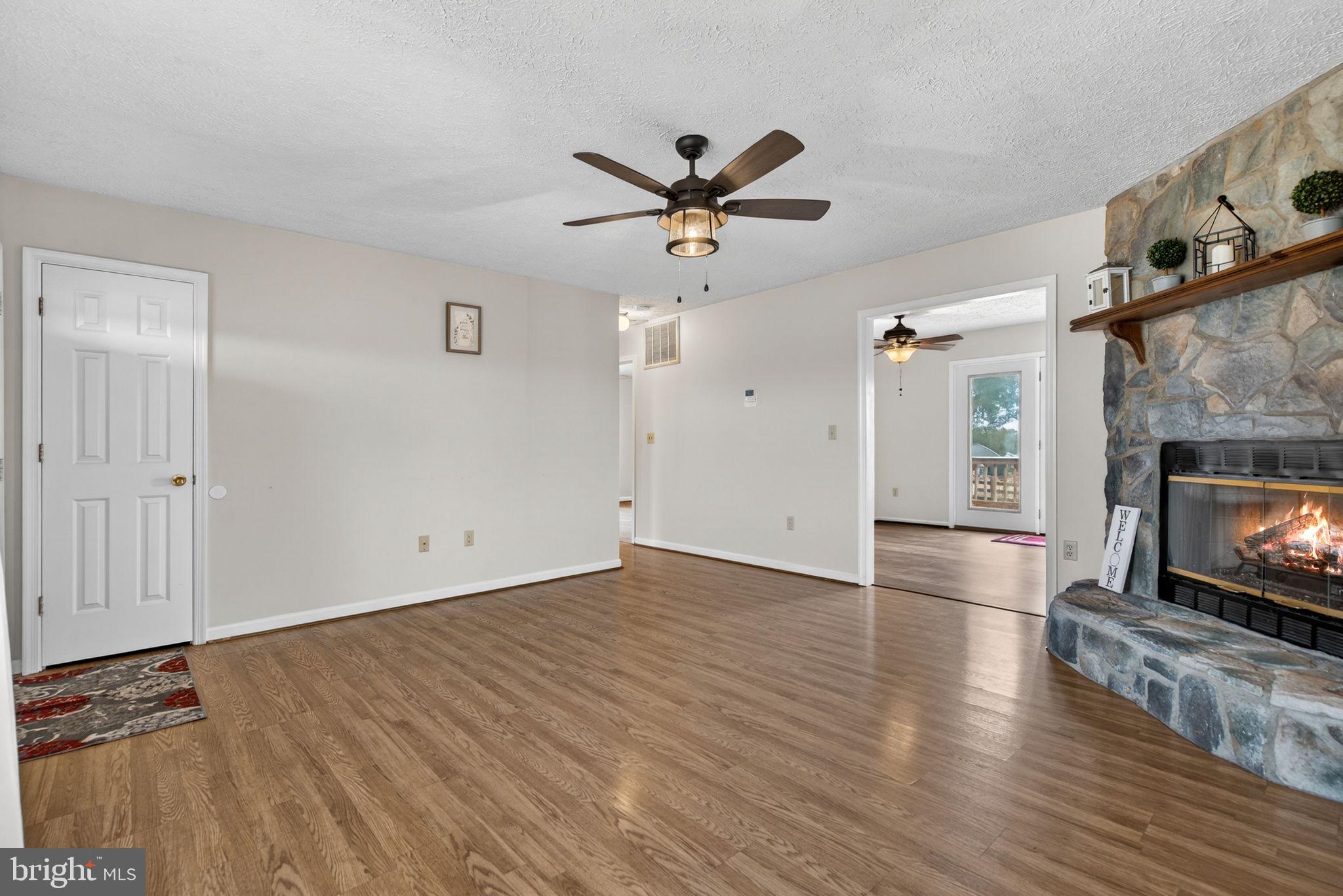 11576 Walters Road Orange, VA 22960 - Photo 17 of 61 wooden floor in an empty room with a fireplace