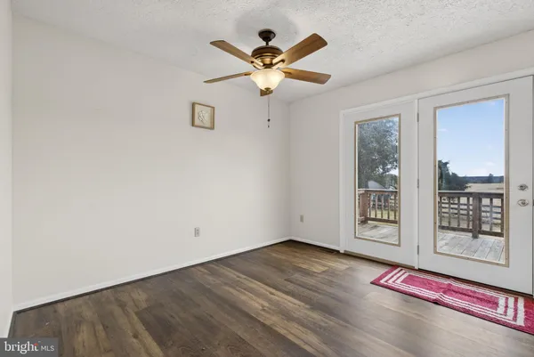 a kitchen with wooden floor and electronic appliances