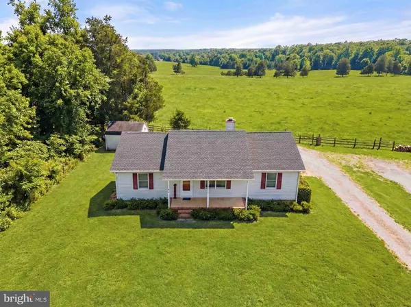 a aerial view of a house with a garden and lake view