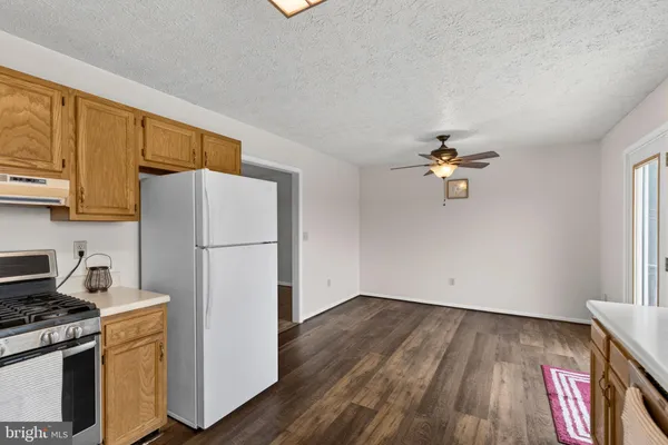 a kitchen with a refrigerator a stove a sink and cabinets