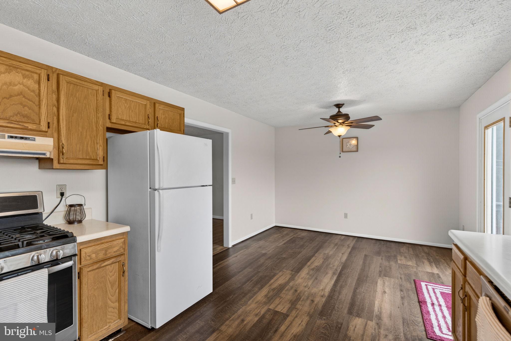 11576 Walters Road Orange, VA 22960 - Photo 22 of 61 a kitchen with wooden floor and electronic appliances