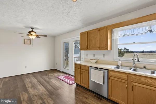 a kitchen with a sink cabinets stainless steel appliances and a window