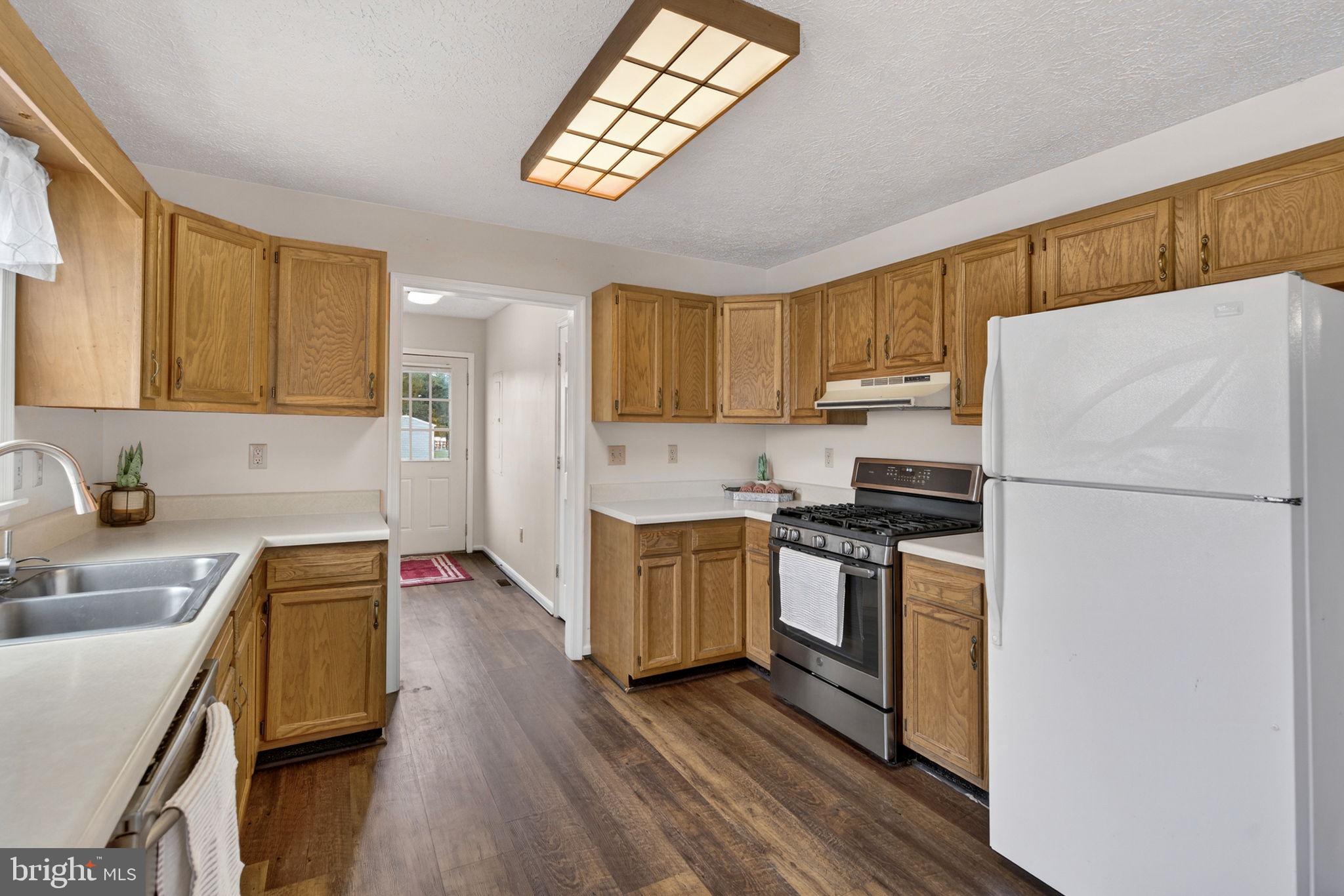 11576 Walters Road Orange, VA 22960 - Photo 24 of 61 a kitchen with a refrigerator a stove a sink and cabinets