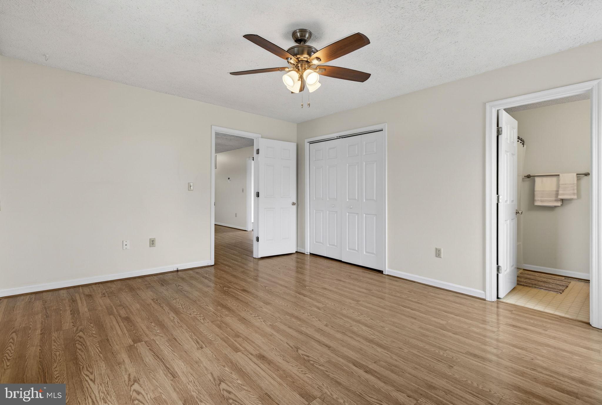 11576 Walters Road Orange, VA 22960 - Photo 33 of 61 an empty room with wooden floor and ceiling fan