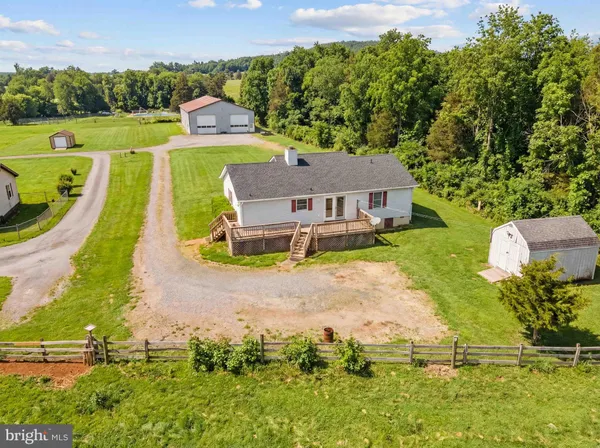 an aerial view of a house with yard swimming pool and outdoor seating