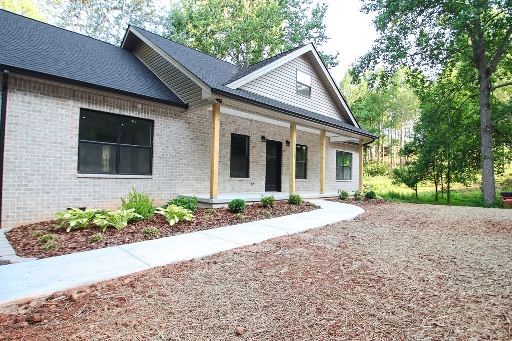329 Webb Drive Sparta, TN 38583 - Photo 3 of 17 a front view of a house with a yard and potted plants