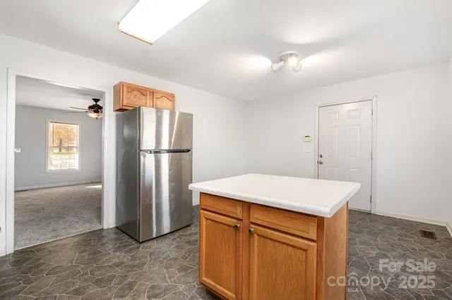 a kitchen with stainless steel appliances granite countertop a refrigerator and a sink