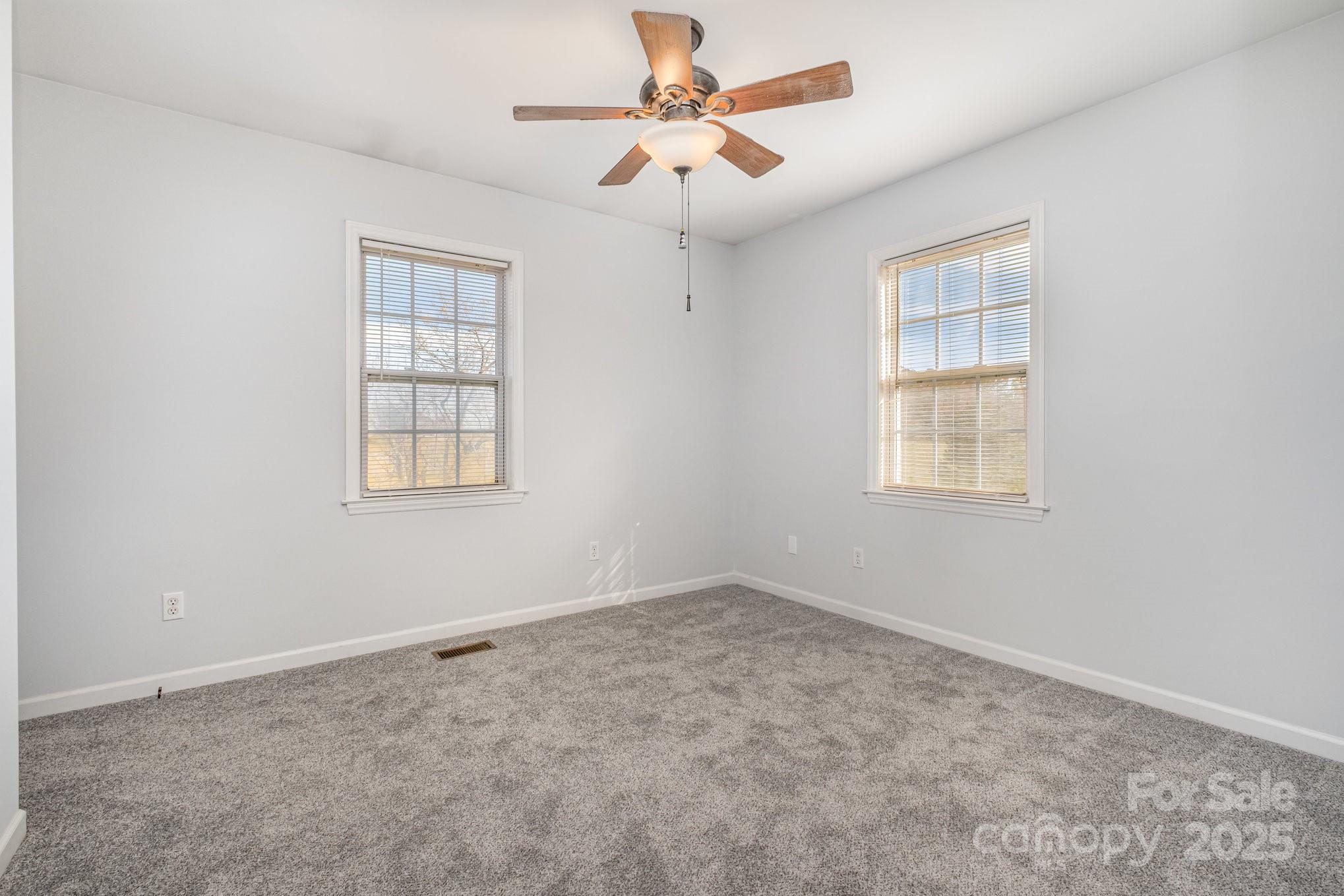 4980 Forest Ridge Drive Hickory, NC 28602 - Photo 17 of 35 an empty room with chandelier fan and windows
