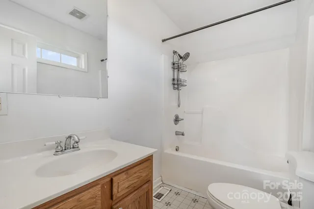 a bathroom with a sink toilet vanity and bathtub