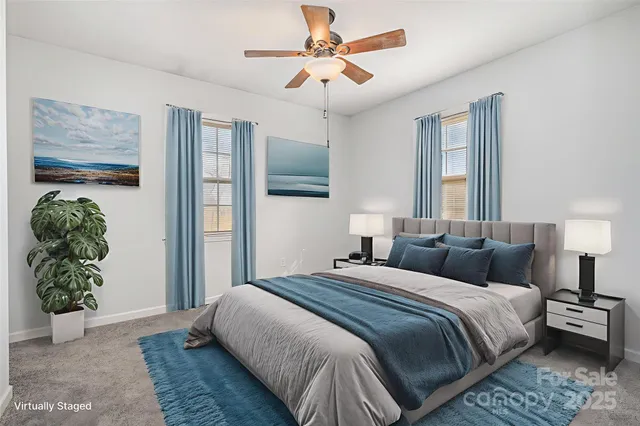 a bedroom with a bed a dresser and potted plant
