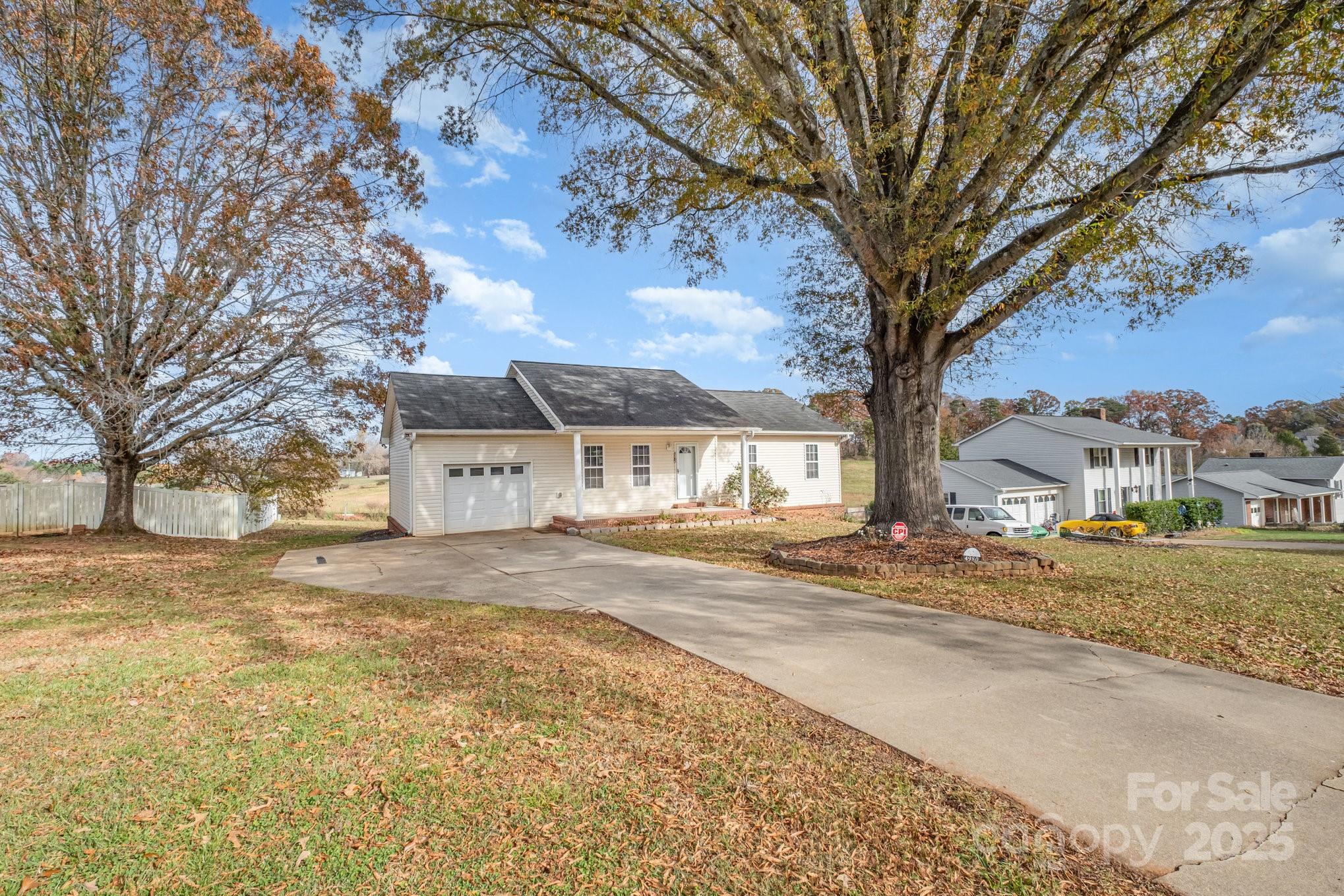 4980 Forest Ridge Drive Hickory, NC 28602 - Photo 3 of 35 a view of a large house with a large tree in front of it