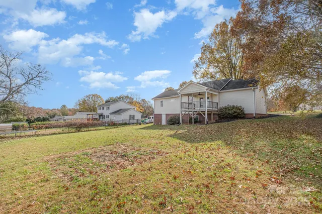 a front view of a house with a yard and lake view