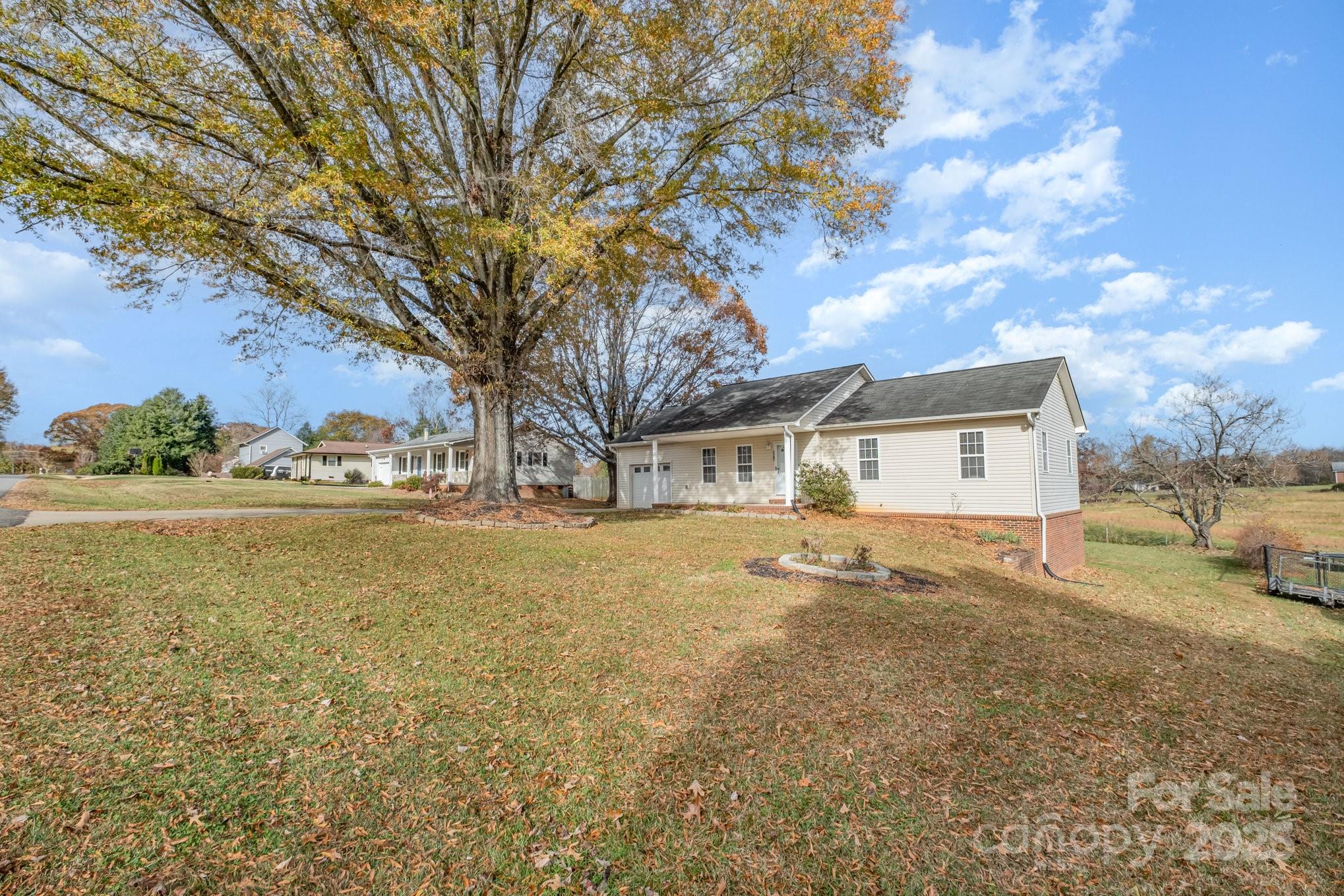 4980 Forest Ridge Drive Hickory, NC 28602 - Photo 4 of 35 a front view of a house with a yard and garage