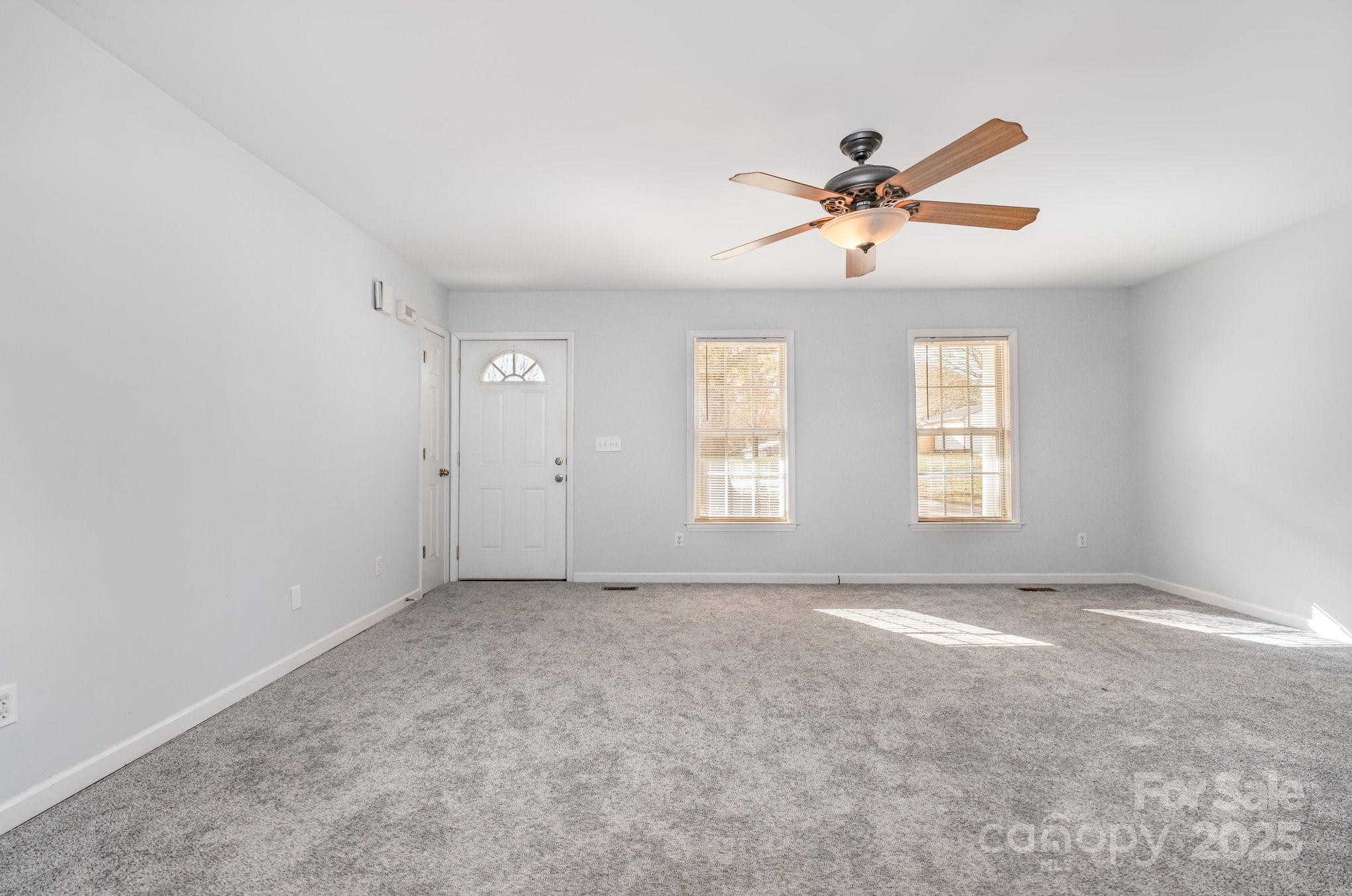 4980 Forest Ridge Drive Hickory, NC 28602 - Photo 5 of 35 a view of a big room with windows and chandelier fan