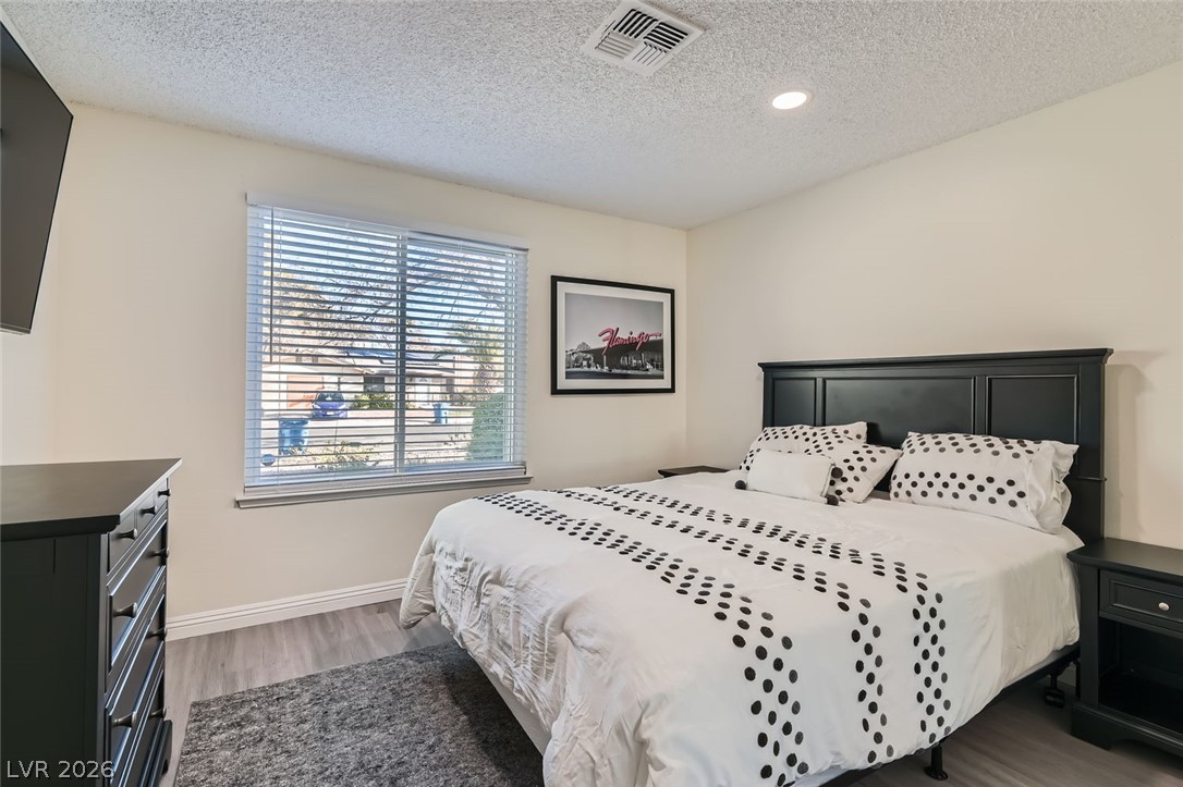 3665 Bronco Road Las Vegas, NV 89103 - Photo 17 of 28 Laminate flooring and bright recessed lighting illuminate this comfortable sleeping space.