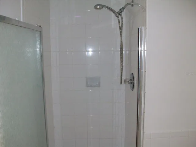 a bathroom with a glass shower door