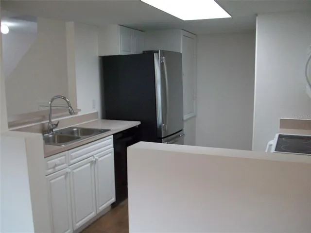 a kitchen with a sink and a refrigerator