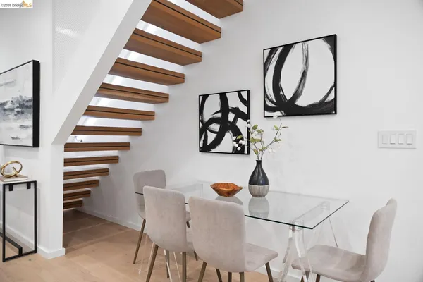 a view of a hallway with two white walls and a painting on the wall