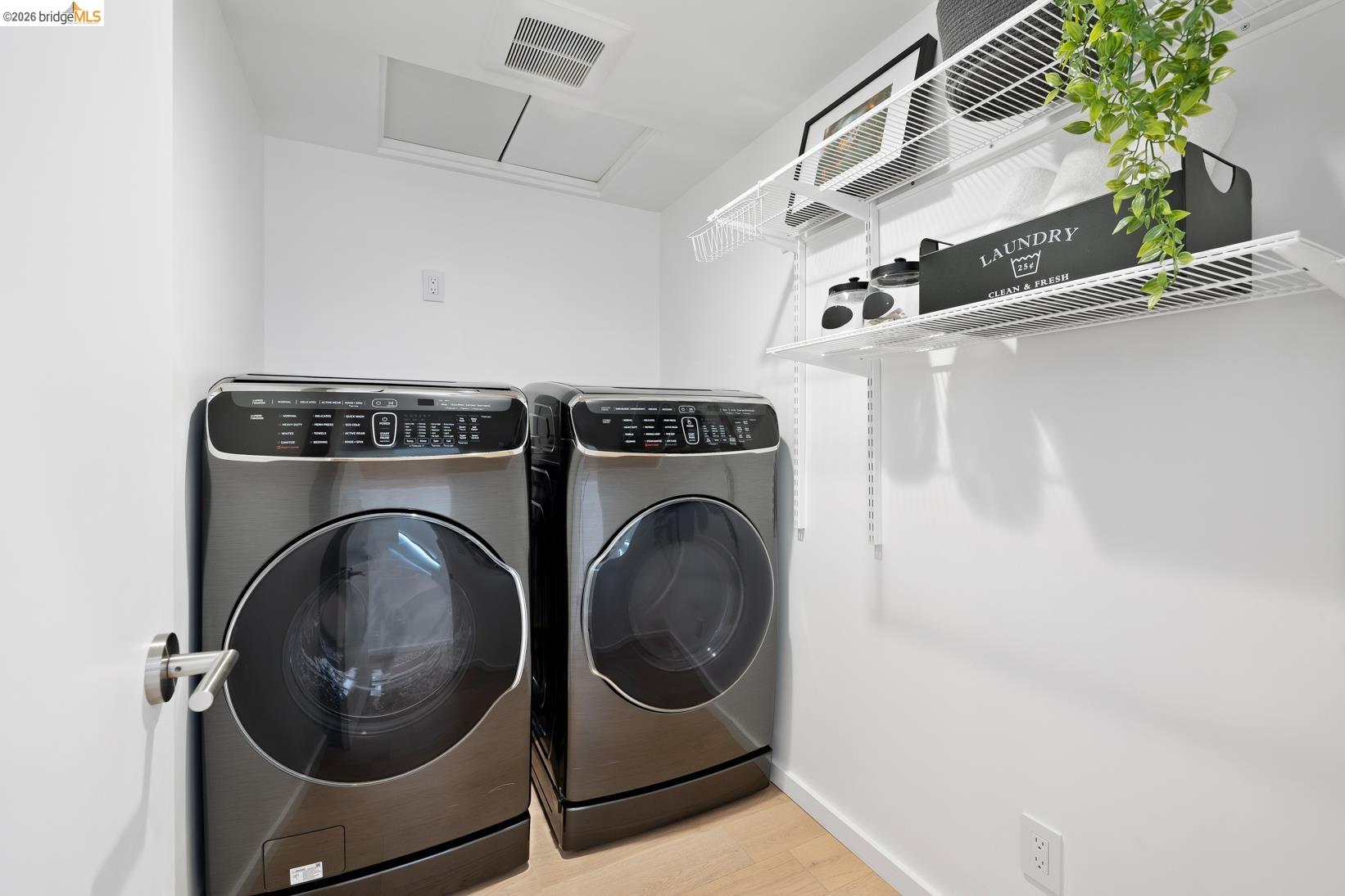 1034 Grayson Street Berkeley, CA 94710 - Photo 20 of 48 Washroom with attic access, washing machine and clothes dryer, and light wood finished floors