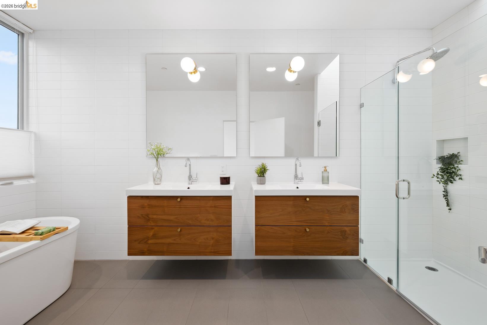 1034 Grayson Street Berkeley, CA 94710 - Photo 26 of 48 Full bath featuring tile walls, a shower stall, two vanities, a soaking tub, and dark tile patterned flooring
