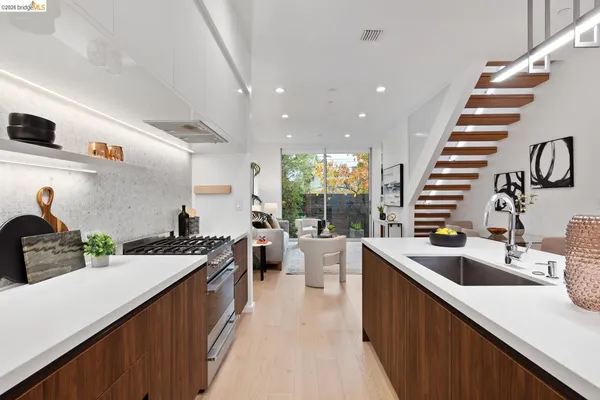 a kitchen with a sink stove and cabinets