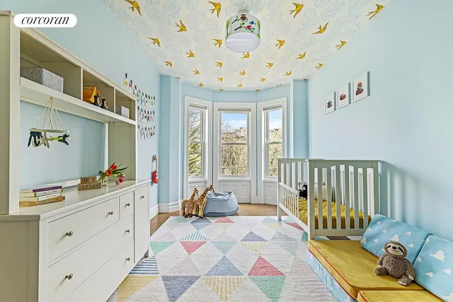 a spacious bedroom with a bed and a window