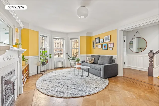 a living room with furniture a window and a fireplace