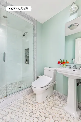 a bathroom with a sink toilet and shower