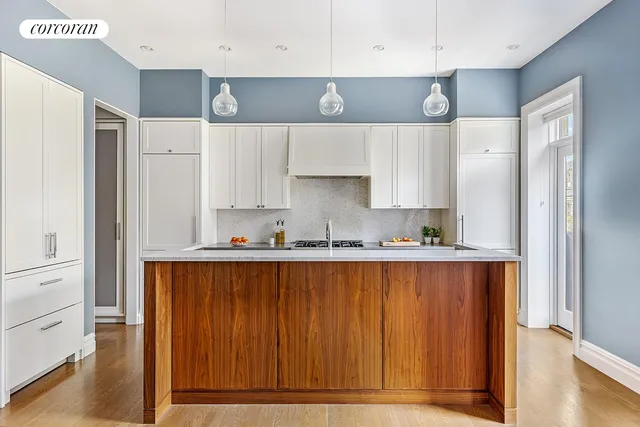 a kitchen with granite countertop a sink cabinets stainless steel appliances and a window