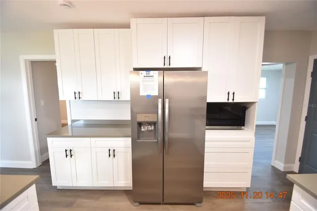a kitchen with a stove and a wooden floor