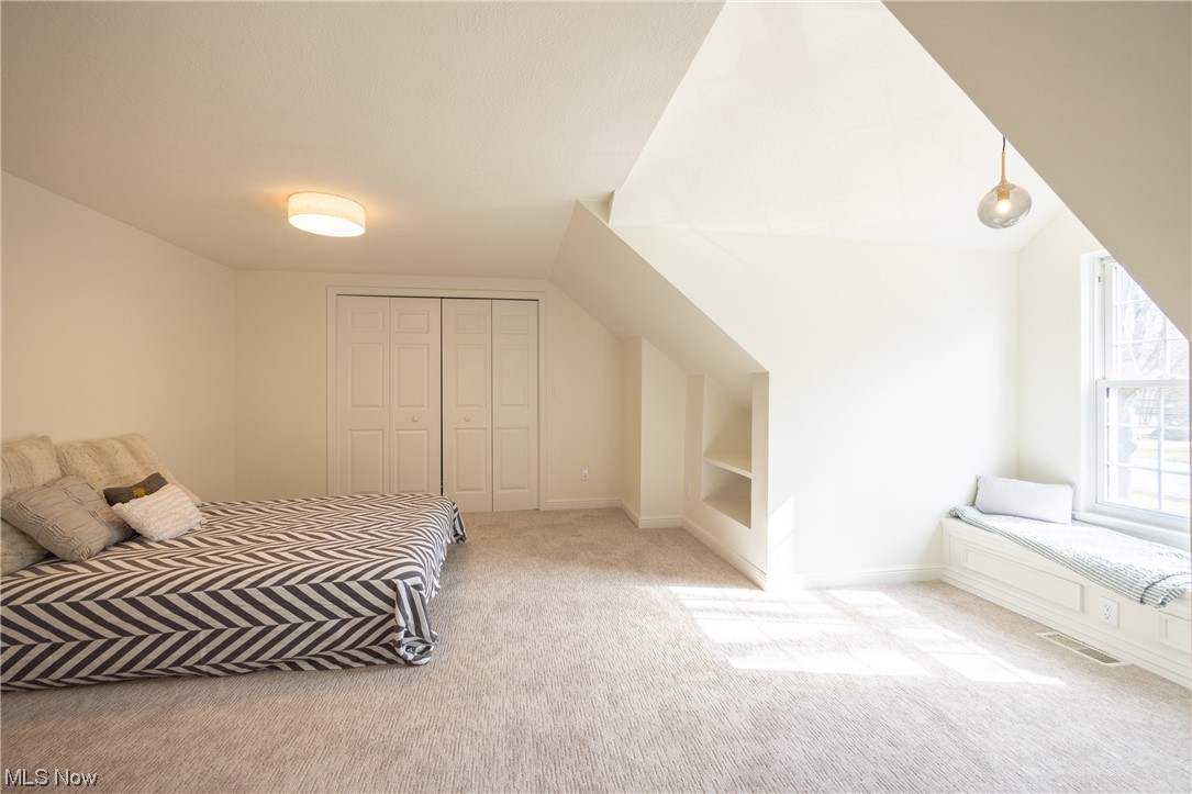 32887 Cedar Road Mayfield Heights, OH 44124 - Photo 15 of 44 Unfurnished bedroom featuring a closet, light carpet, and lofted ceiling
