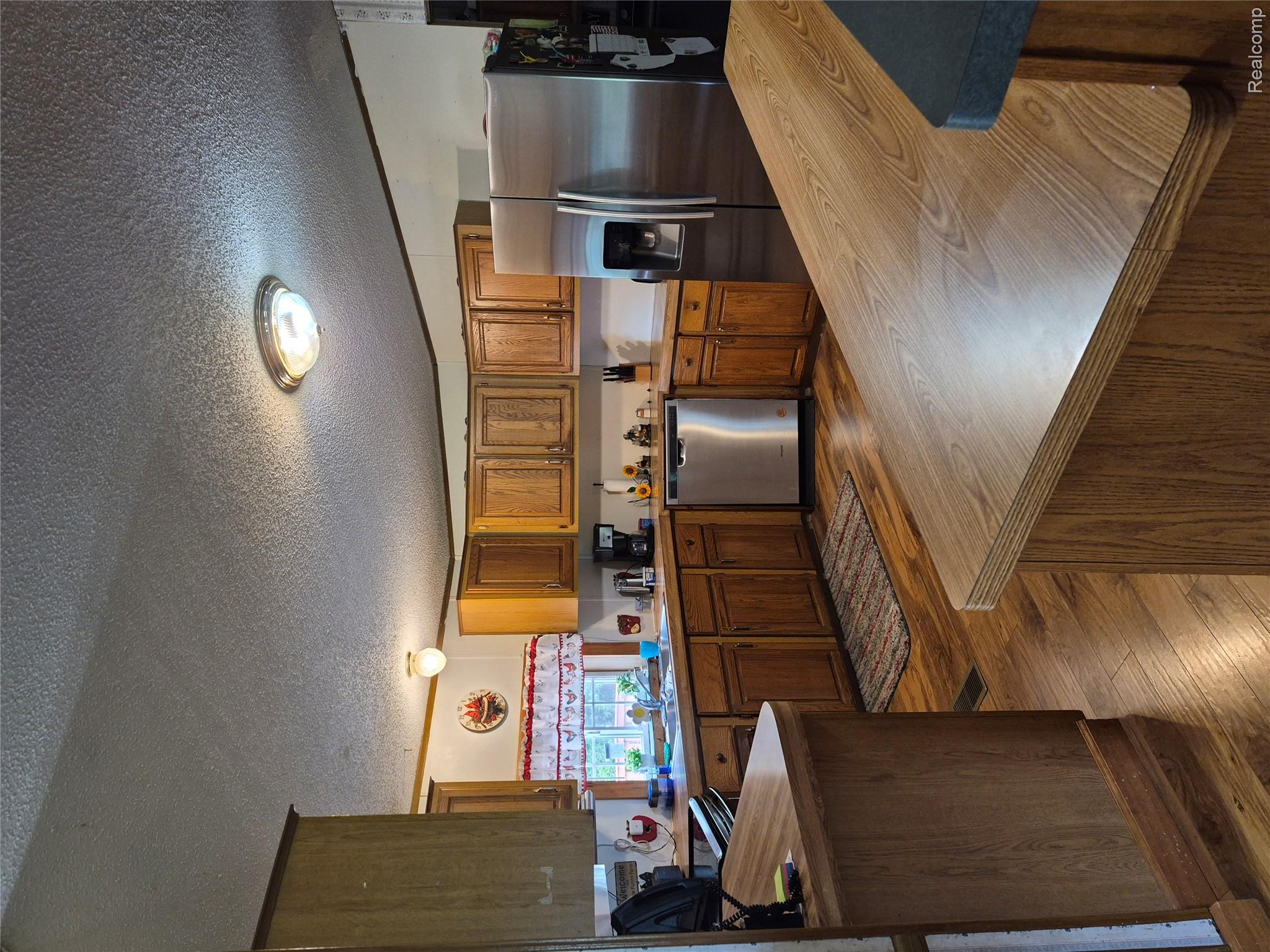12849 South Delaney Road Perry, MI 48872 - Photo 25 of 34 Kitchen featuring wood-finish flooring, wood cabinetry, and stainless steel appliances