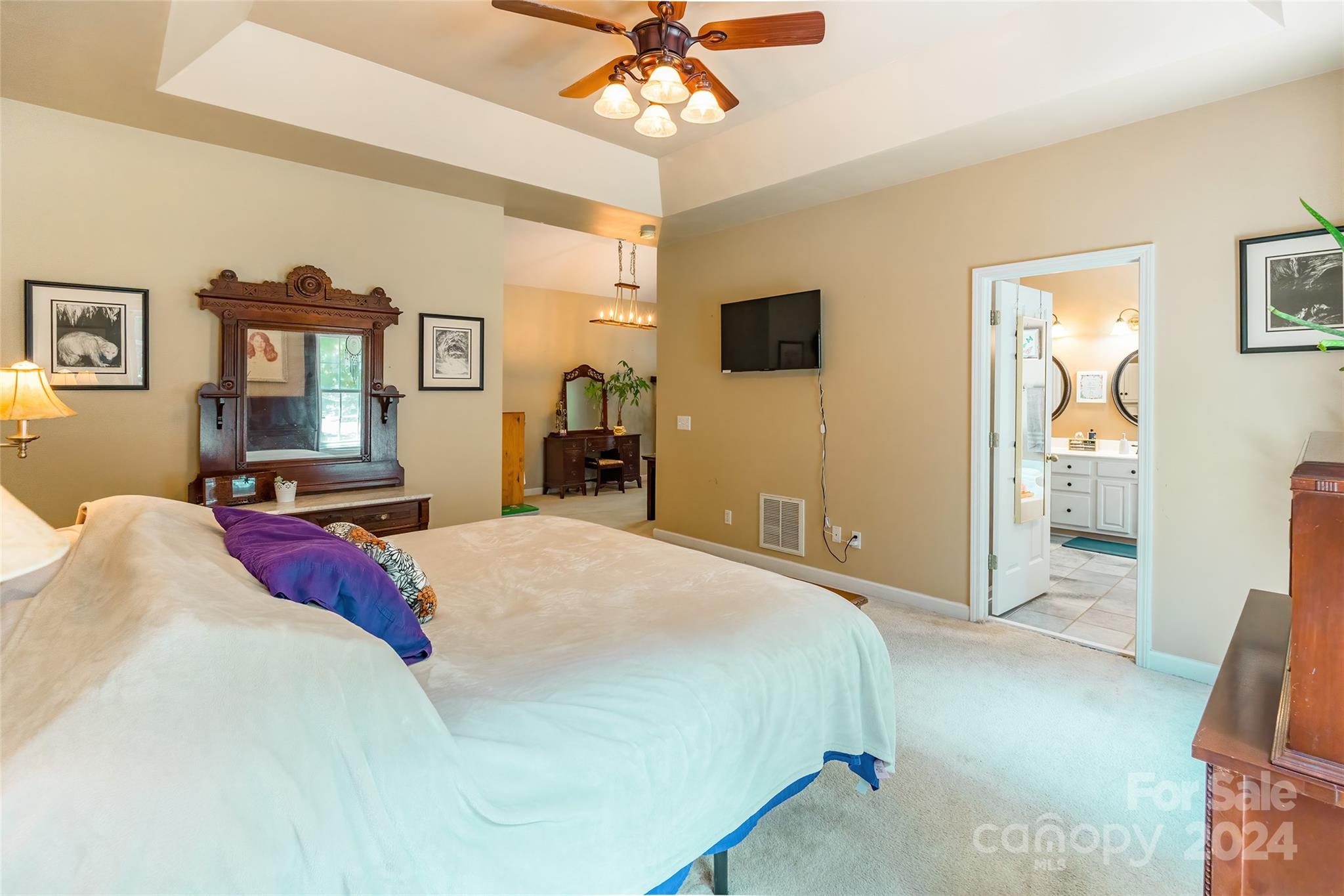 4710 Steepleton Way Charlotte, NC 28215 - Photo 15 of 29 a spacious bedroom with a bed and a chandelier