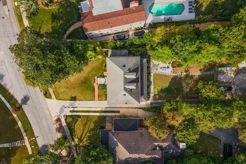 an aerial view of a house with a yard
