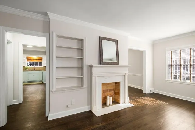 a view of a livingroom with a fireplace and window