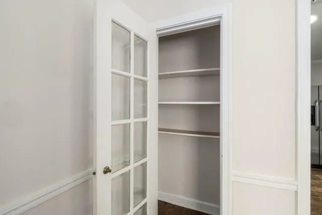 a view of walk in closet with empty racks